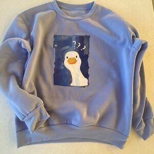 Blue Graphic women’s Sweater size small Duck graphic design never worn.